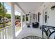 Charming front porch featuring white railings, columns, and comfortable outdoor furniture at 1920 Iris St, North Charleston, SC 29405