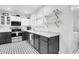 Bright kitchen with black cabinets, stainless steel appliances, marble counters, and decor tile floors at 1920 Iris St, North Charleston, SC 29405