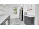 Galley kitchen with stainless steel appliances, marble counters, and decorative tile floors at 1920 Iris St, North Charleston, SC 29405