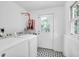 Clean laundry area with washer, dryer, utility sink and decor tiled floors at 1920 Iris St, North Charleston, SC 29405