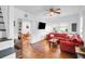 Spacious living room with hardwood floors, a TV, and an adjacent dining area at 1920 Iris St, North Charleston, SC 29405