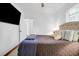 Bright main bedroom with a tufted headboard, TV, and natural light at 1920 Iris St, North Charleston, SC 29405