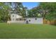 Expansive backyard featuring a well-maintained lawn, a classic white two-story home, and a spacious deck for outdoor enjoyment at 1986 Elaine St, Johns Island, SC 29455