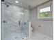 Modern bathroom showcasing a frameless glass shower with marble-style tiling and mosaic tile floor at 1986 Elaine St, Johns Island, SC 29455