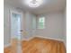 Bedroom with hardwood floors, neutral paint, and a door to the bathroom at 1986 Elaine St, Johns Island, SC 29455