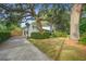 View of home from long driveway, highlighting trees and landscaping at 1986 Elaine St, Johns Island, SC 29455