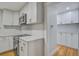 Modern kitchen showcasing white cabinets, stainless steel appliances, and a stylish herringbone tile backsplash at 1986 Elaine St, Johns Island, SC 29455