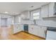 Charming kitchen featuring sleek white cabinetry, stainless steel appliances, and an elegant herringbone backsplash at 1986 Elaine St, Johns Island, SC 29455