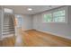 Bright living room with hardwood floors, staircase, and natural light streaming through the windows at 1986 Elaine St, Johns Island, SC 29455