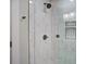 Up close shot of shower with white tile with black accents with a clear glass door and black hardware at 1986 Elaine St, Johns Island, SC 29455