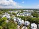 Scenic aerial view of a neighborhood with white houses surrounding a pristine lake and lush green landscape at 2229 Boatwright Rd, Johns Island, SC 29455