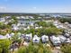 Expansive aerial view of a stunning neighborhood, showcasing beautiful homes, lush trees, and a serene lake at 2229 Boatwright Rd, Johns Island, SC 29455