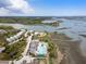 Picturesque aerial view showcasing a waterfront resort with a large pool, marina, and stunning coastal landscape at 2229 Boatwright Rd, Johns Island, SC 29455