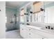 Elegant bathroom featuring double vanities, a glass-enclosed shower, and light blue walls at 2229 Boatwright Rd, Johns Island, SC 29455