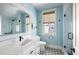 Bright bathroom featuring modern fixtures, white vanity, glass shower and a window for natural light at 2229 Boatwright Rd, Johns Island, SC 29455