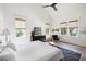 Bright bedroom featuring three large windows, a dark wood dresser, and a zebra-print rug at 2229 Boatwright Rd, Johns Island, SC 29455