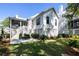 Stunning view of the back of the home with a spacious patio, lush green lawn, and beautiful landscaping at 2229 Boatwright Rd, Johns Island, SC 29455