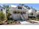 Charming two-story white home with a lovely front porch, garage, and well-manicured landscaping at 2229 Boatwright Rd, Johns Island, SC 29455