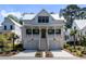 Beautiful two-story home with a welcoming front porch, two-car garage, and lush landscaping at 2229 Boatwright Rd, Johns Island, SC 29455
