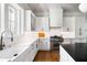 Well-appointed kitchen with white cabinetry, stainless steel appliances, and a farmhouse sink at 2229 Boatwright Rd, Johns Island, SC 29455
