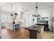 Open concept kitchen and dining area featuring a large island, pendant lighting, and modern appliances at 2229 Boatwright Rd, Johns Island, SC 29455