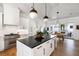 Modern kitchen with white cabinets, stainless steel appliances, and a large island with seating at 2229 Boatwright Rd, Johns Island, SC 29455