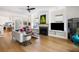 Bright living room featuring a fireplace, modern furnishings, and hardwood floors at 2229 Boatwright Rd, Johns Island, SC 29455