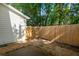 Backyard with a privacy fence, trees, and gravel at 241 Howle Ave # F, Charleston, SC 29412