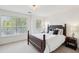 Bedroom with natural light, and neutral walls and carpeting with a wood bed frame at 241 Howle Ave # F, Charleston, SC 29412