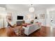 Cozy living room featuring hardwood floors, a large window, modern lighting and comfortable seating at 241 Howle Ave # F, Charleston, SC 29412