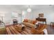 Spacious living room featuring hardwood floors, a large window, modern lighting and comfortable seating at 241 Howle Ave # F, Charleston, SC 29412