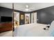 Spacious main bedroom with a four-poster bed, ceiling fan, ensuite bathroom and walk-in closet at 241 Howle Ave # F, Charleston, SC 29412