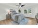 Bright bedroom featuring a ceiling fan, hardwood floors, and large windows at 2462 Swallow Dr, Charleston, SC 29414