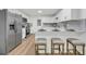 Modern white kitchen featuring stainless steel appliances, light countertops and breakfast bar at 2462 Swallow Dr, Charleston, SC 29414