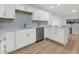 Bright kitchen featuring white cabinets, stainless steel dishwasher, and light countertops at 2462 Swallow Dr, Charleston, SC 29414