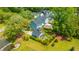 Aerial view of a neighborhood with colorful homes, lush trees, and a serene pond at 2596 Hatch Dr, Johns Island, SC 29455