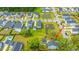 Aerial view of a neighborhood featuring neatly arranged houses, ponds, and manicured green spaces at 2596 Hatch Dr, Johns Island, SC 29455