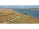 A picturesque aerial view of a dock, a creek, and colorful kayaks ready for a day on the water at 2596 Hatch Dr, Johns Island, SC 29455