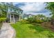 Green backyard with a stone walkway, lush lawn and the side of the home at 2596 Hatch Dr, Johns Island, SC 29455