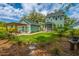 Spacious backyard featuring a well-manicured lawn, patio with pergola, and vibrant landscaping at 2596 Hatch Dr, Johns Island, SC 29455