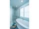 This primary bathroom boasts a soaking tub and glass enclosed shower with floor to ceiling tile at 2596 Hatch Dr, Johns Island, SC 29455
