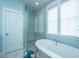 Bright bathroom featuring a soaking tub and a glass enclosed shower at 2596 Hatch Dr, Johns Island, SC 29455