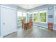 Bright dining room features large windows and a rustic wood table perfect for gathering and entertaining at 2596 Hatch Dr, Johns Island, SC 29455