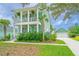 Two-story home with double porches, palm trees and a detached garage at 2596 Hatch Dr, Johns Island, SC 29455
