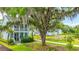 Two-story home with a charming porch, complemented by lush landscaping and an inviting pond at 2596 Hatch Dr, Johns Island, SC 29455