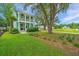Well-manicured lawn in front of a lovely two-story house with double porches at 2596 Hatch Dr, Johns Island, SC 29455