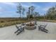 Outdoor fire pit area with comfortable Adirondack chairs, perfect for enjoying cool evenings at 2596 Hatch Dr, Johns Island, SC 29455