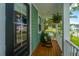 Cozy front porch with rocking chair and hanging fern, overlooking a quiet street at 2596 Hatch Dr, Johns Island, SC 29455
