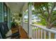 Charming front porch with rocking chairs and a view of the street at 2596 Hatch Dr, Johns Island, SC 29455