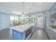Bright kitchen boasts stainless appliances, large island with quartz countertops, and plenty of natural light at 2596 Hatch Dr, Johns Island, SC 29455